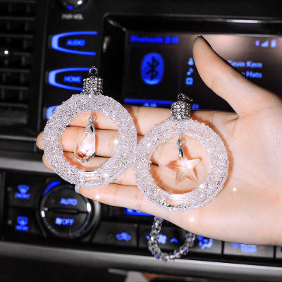 Sparkling crystal star pendant for car rearview mirror with silver alloy chain reflecting sunlight