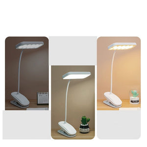 White flexible clip-on LED lamp attached to a wooden desk for study use